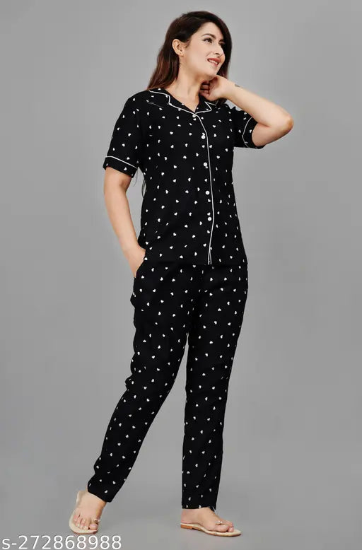 Women's black rayon printed nightsuits with short sleeves and matching top & bottom, featuring intricate designs on display
