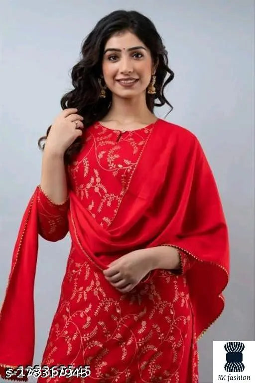 Red rayon kurti with gharara, embellished net design for women or girls. Rayon material, three-quarter sleeves, includes dupatta and bottomwear. Indian origin
