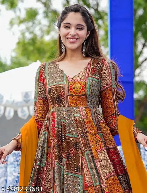 Exquisite orange rayon Anarkali gown for weddings & parties, featuring printed net and half inner. Sleeveless, fully flared dress in M, L, XL, XXL sizes. Made in India. (Up to 56 inches long, 3.5 mtr flair)