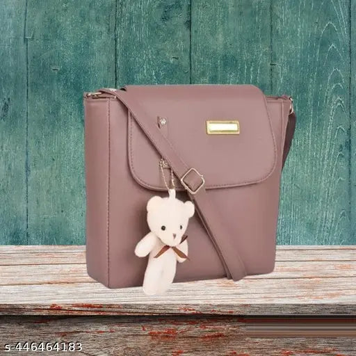 Stylish PU leather handbag with adorable teddy bear charm, perfect for women and girls. Free size, 2 compartments, solid pattern