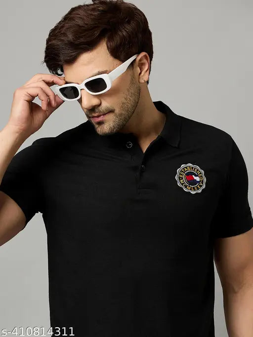 Men's embroidered half sleeves cotton blend polo neck t-shirt. Classic black-on-denim look with printed pattern, perfect for casual wear with jeans and sneakers. Made in India