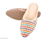 Colorful, embellished Rajasthani flat juttis for girls and women, handcrafted in India. Slip-on design with vibrant colors and mesh fastening. Perfect for ethnic and festive outfits