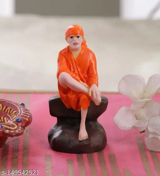 Orange poly resin Shirdi Sai Baba poshak, intricately hand-painted idol figurine on display shelf