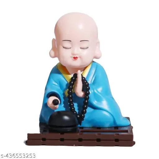 Solar-powered Buddha Monk Statue, shaking head & hand. High-quality solar decor for car dashboard, home, office. Enhances health, wealth, prosperity. Ideal for desks, windows, gifting occasions. Made of plastic with solar light panel
