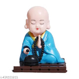 Solar-powered Buddha Monk Statue, shaking head & hand. High-quality solar decor for car dashboard, home, office. Enhances health, wealth, prosperity. Ideal for desks, windows, gifting occasions. Made of plastic with solar light panel