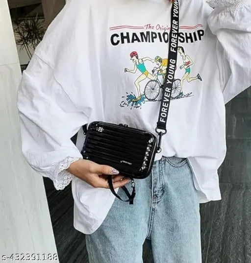 Solid PVC Forever Young sling bag for women and girls. Crossbody & mini suitcase box, multi pattern with detachable strap, waterproof case, and RFID protection. Indian-origin fashion accessory