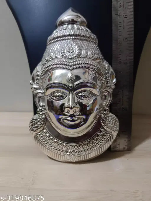 Brass Indian god idol - Lakshmi face, Lakshmi Mukhuta, intricately detailed figure on display