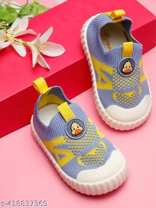 Sky Blue & Yellow cotton slip-on shoes for toddler boys, featuring PVC sole and EVA insole for comfort during first steps. Cartoon character pattern adds style to early adventures