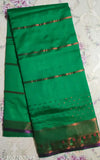 Parrot green Banarsi silk saree with copper zari benteax border, all-over kalajali design. Elegant bridal color for women's wear, smooth chiffon fabric