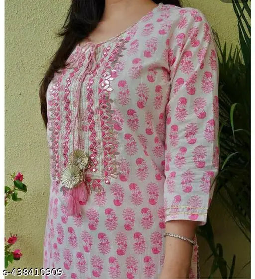 Pink rayon kurta & palazzos set, printed net design, three-quarter sleeves, Indian ethnic wear on green backdrop
