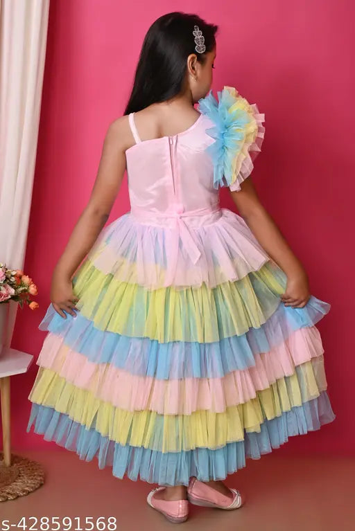 Multicolor rainbow unicorn net frock for toddlers, printed with magical patterns on display