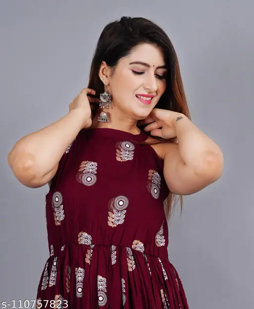 Peacock feather rayon anarkali kura, printed sleeveless dress in peachy shades for women, fashionable Indian outfit on display