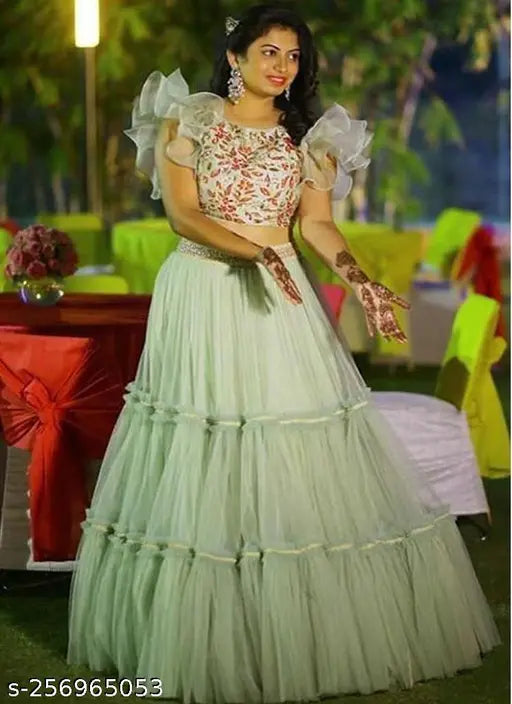 Light green net lehenga choli with lace work and semi-stitching, featuring an embellished satin blouse. Indian designer party wear for functions and festive occasions