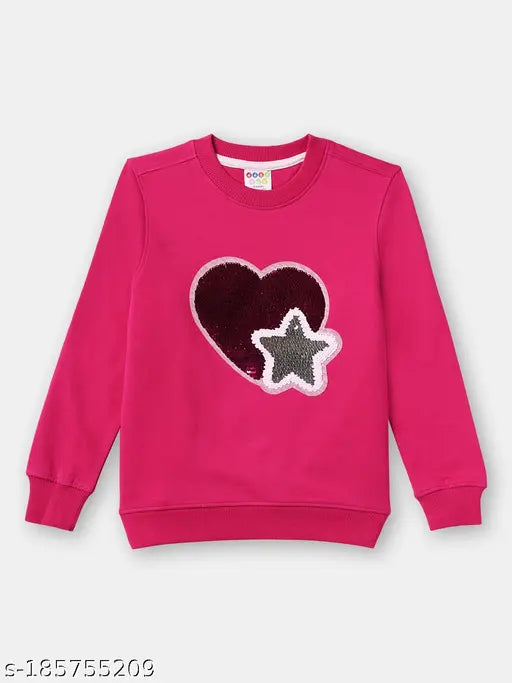 Reversible heart sequinned cotton sweatshirt for girls with long sleeves, soft fabric, and durable design. Embellished net pattern and sequin highlights on both sides. Available in sizes 2-3 years (bust 22 in, length 15 in), 3-4 years (bust 23 in, length 16 in), 4-5 years (bust 24 in, length 17 in), and 7-8 years (bust 28 in, length 19 in). Made in India