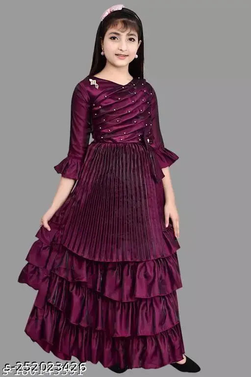 Premium purple silk ethnic gown with moti's, suitable for girls 3-12 years. Indian-inspired design, embellished net pattern, and three-quarter sleeves