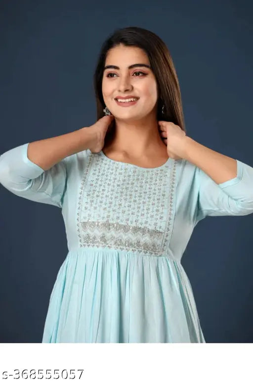 Rayon embroidered tiered kurti for women, solid pattern, three-quarter sleeves. Handcrafted Indian clothing with traditional and western elements." (123 characters)