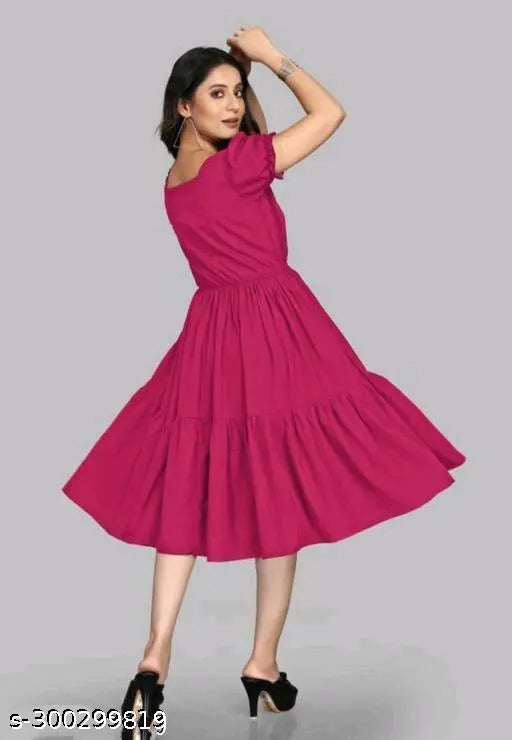 Pink rayon short-sleeved party dress for women, stylish and festive attire on mannequin