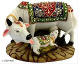 Marble dust/Polyresin Cow and Calf decorative item, Rakhi Special. Detailed handicraft featuring precious stones, ideal for religious home decor in the North East direction