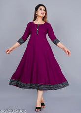Purple rayon round flared kurti with three-quarter sleeves, solid print design. Hand wash or machine wash. Size ranges from XS to XXXL. Perfect for casual and formal occasions. Made in India