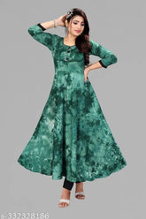Green rayon Anarkali kurti with patched designer motif, suitable for office wear, social gatherings, or important occasions. Comfortable and breathable cotton lining. Available in sizes XXL (44 in bust) and XXXL (46 in bust). Indian-inspired fashion for various occasions