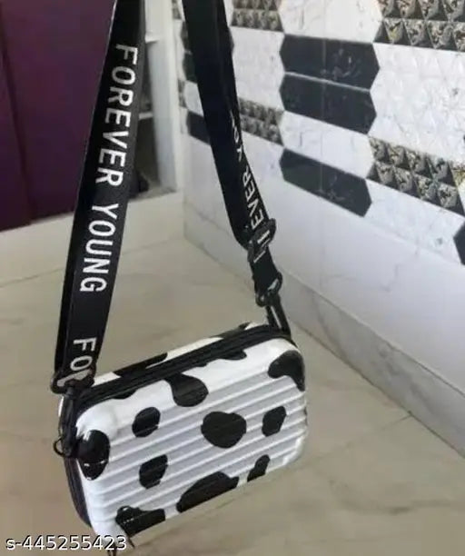 Black and white acrylic print net sling bag with detachable shoulder strap. Versatile women's accessory converts to cosmetic box bag