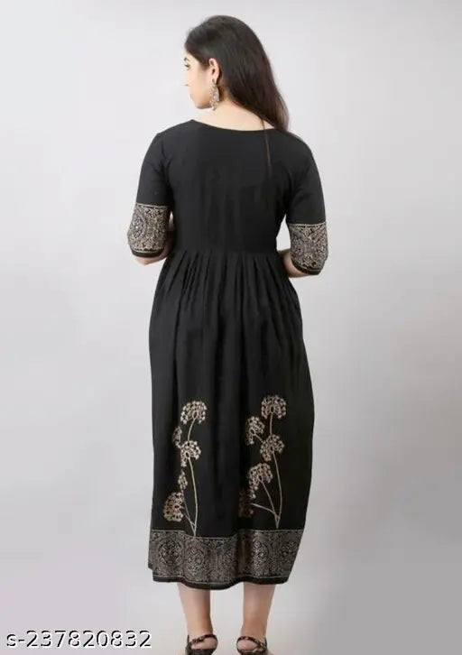 Black printed rayon flared kurta with three-quarter sleeves and round neck, ideal for casual or formal wear. Hand block pattern adds unique charm. Made in India