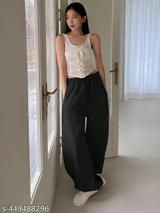 Black straight-fit joggers with pockets, solid net material for women's sleepwear or casual wear