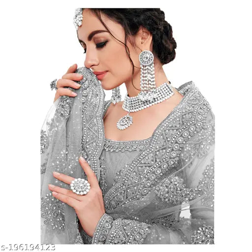Gold-toned embroidered net lehenga choli with zari work, semi-stitched, Indian bridal wear on mannequin