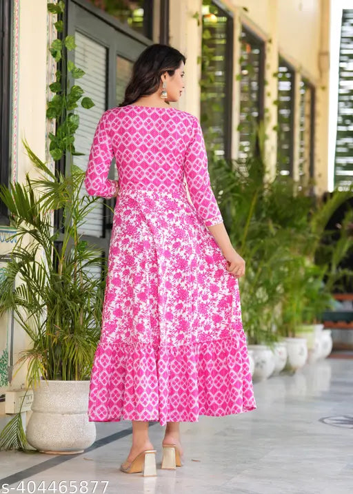 Pink rayon long-tiered kurtis with embroidered yoke, vibrant print and tassels. Vibrant Indian kurti with flowing tiers on bust." (108 characters)