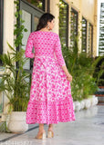 Pink rayon long-tiered kurtis with embroidered yoke, vibrant print and tassels. Vibrant Indian kurti with flowing tiers on bust." (108 characters)