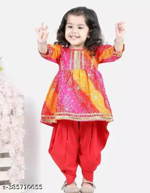 Red bandhej kurta and dhoti set for girls, three-quarter sleeves with lace embellishments. Printed rayon fabric, anarkali shape. Sizes: 12-18 months, 18-24 months, 1-2 years, 2-3 years, 3-4 years, 4-5 years, 5-6 years, 6-7 years, 7-8 years. Origin: India