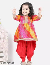 Red bandhej kurta and dhoti set for girls, three-quarter sleeves with lace embellishments. Printed rayon fabric, anarkali shape. Sizes: 12-18 months, 18-24 months, 1-2 years, 2-3 years, 3-4 years, 4-5 years, 5-6 years, 6-7 years, 7-8 years. Origin: India