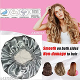 Grey satin silk hair bonnet cap with premium silk scrunchies for curly hair. Adjustable and stretchable for comfortable wear, ideal for sleeping or home cleaning. Protects fragile hair from dryness, breakage, sound & dust, and heat. Made with double-layered reversible design and includes 1 cap with 3 free soft scrunchies. Origin: India (13.6 x 11.4 x 5.6 INCH, approx. 60 g)