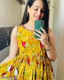 Yellow cotton printed sleeveless gown for women and girls, vibrant floral pattern on a sunny day