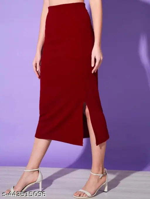 High-waisted black polycotton pencil midi skirt with side slit, ideal for women's casual and formal wear. Versatile design pairs well with tops and tights. Black elastic waist skirt (26-36 waist sizes). Made in India