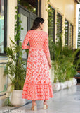Orange rayon long-tiered kurti with embroidered yoke, vibrant printed combo, three-quarter sleeves. Vibrant Indian garment with tassels and multiple colors." (125 characters)