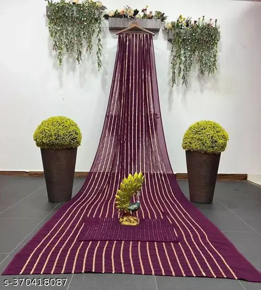 Purple Georgette embroidered saree and blouse piece, adorned with golden zardozi work and fancy fringe embroidery, perfect for parties or auspicious occasions. Hand-washable in India." (120 characters)