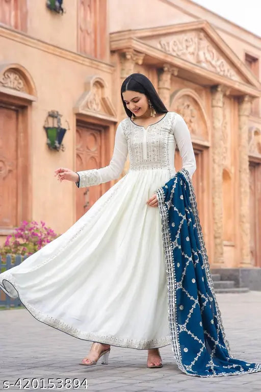Premium designer cotton Cambric Anarkali gown with embroidered net, sequins, tassels, and matching dupatta, Indian wedding wear on display stand