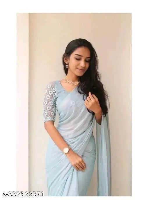 Shimmer grey Georgette saree with striped, embroidered net blouse on mannequin