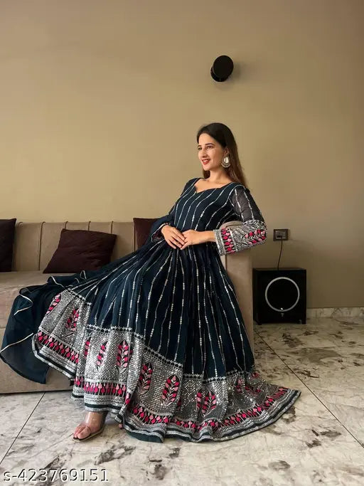 Designer blue party wear Anarkali suit in georgette fabric with striped net pattern, three-quarter sleeves. Size S, M, L, XXL available. Elegant embroidery, perfect for professional events. Color may vary due to photographic effects. Genuine product by Fashion Basket. Origin: India