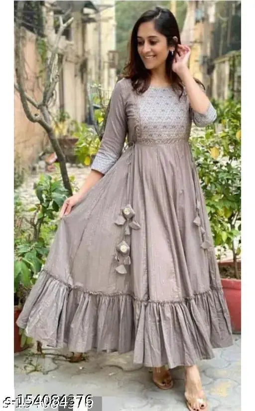 Grey rayon Anarkali kurta, embroidered with tassels and latkans. Three-quarter sleeves, ankle length for festive women's wear. Elegant grey, intricate zari work, premium quality