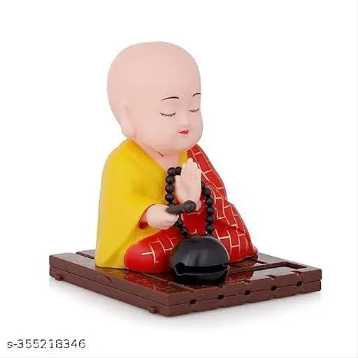 Multicolor solar-powered moving head Buddha showpiece for home decor, 9cm height. Eco-friendly design brings serenity to any space