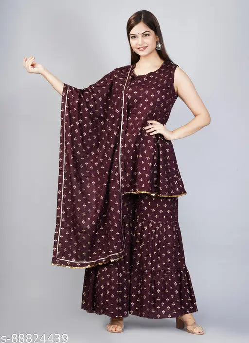 Hand-block printed rayon kurta set with sharara and dupatta, intricately embellished with gold details. Indian fashion essential. Made in India, size S-L