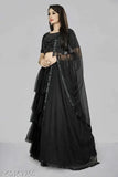 Black embroidered semi-stitched Lehenga Choli on mannequin with net dupatta, satin choli and ruffled bottom