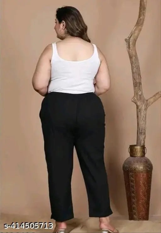 Black cotton blend trousers with side pockets for plus size women, featuring elastic waistband and stretchable fit