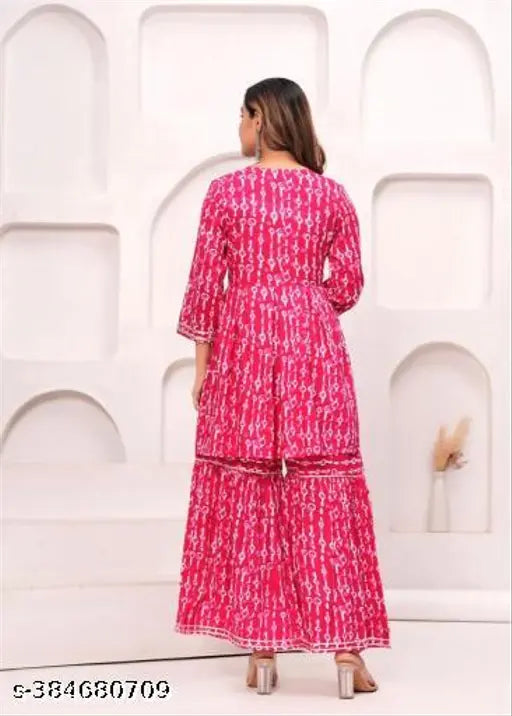 Pink cotton rayon kurta sharara dupatta set with intricate embellishments, floral print, and lacework. Set includes a pair of elasticated sharara pants and dupatta. Perfect for festive celebrations. Indian-made, sizes XS to XXL
