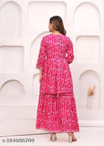 Pink cotton rayon kurta sharara dupatta set with intricate embellishments, floral print, and lacework. Set includes a pair of elasticated sharara pants and dupatta. Perfect for festive celebrations. Indian-made, sizes XS to XXL