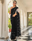 Black Georgette botanical saree with printed net blouse, embellished in gold & white. Single piece from SIRIL, India. May vary slightly due to screen resolution and photography effects. Free Size (Saree Length: 5.5m, Blouse Length: 0.8m)