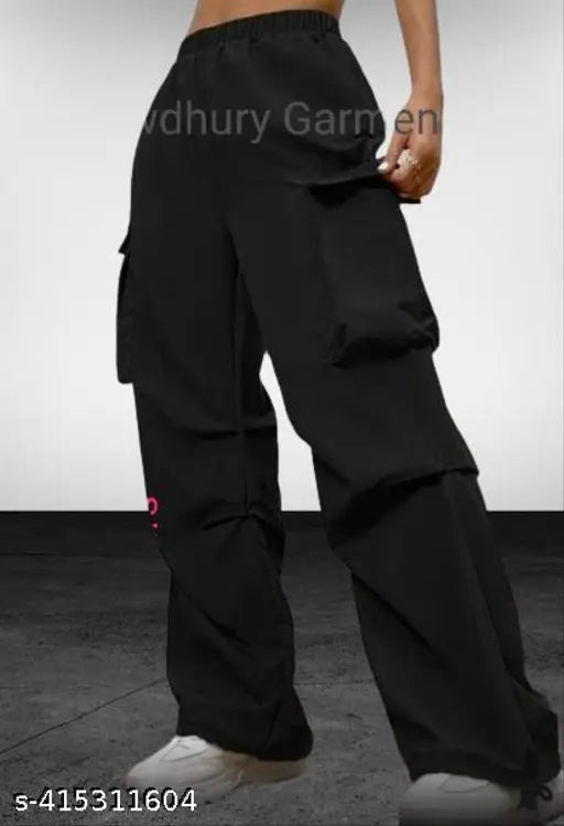 Black parachute cargo pant for women, high-rise elastic waistband, durable polyester, wide-leg silhouette, spacious cargo pockets, adjustable drawstring cuffs, versatile length 38-40 inches, made in India