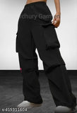 Black parachute cargo pant for women, high-rise elastic waistband, durable polyester, wide-leg silhouette, spacious cargo pockets, adjustable drawstring cuffs, versatile length 38-40 inches, made in India